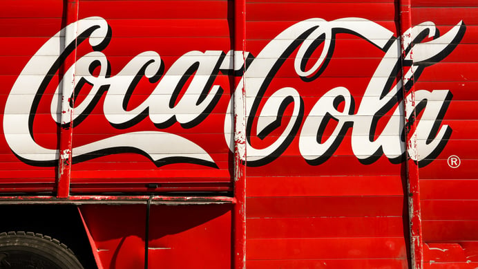 Coca-Cola written on the truck with red background.